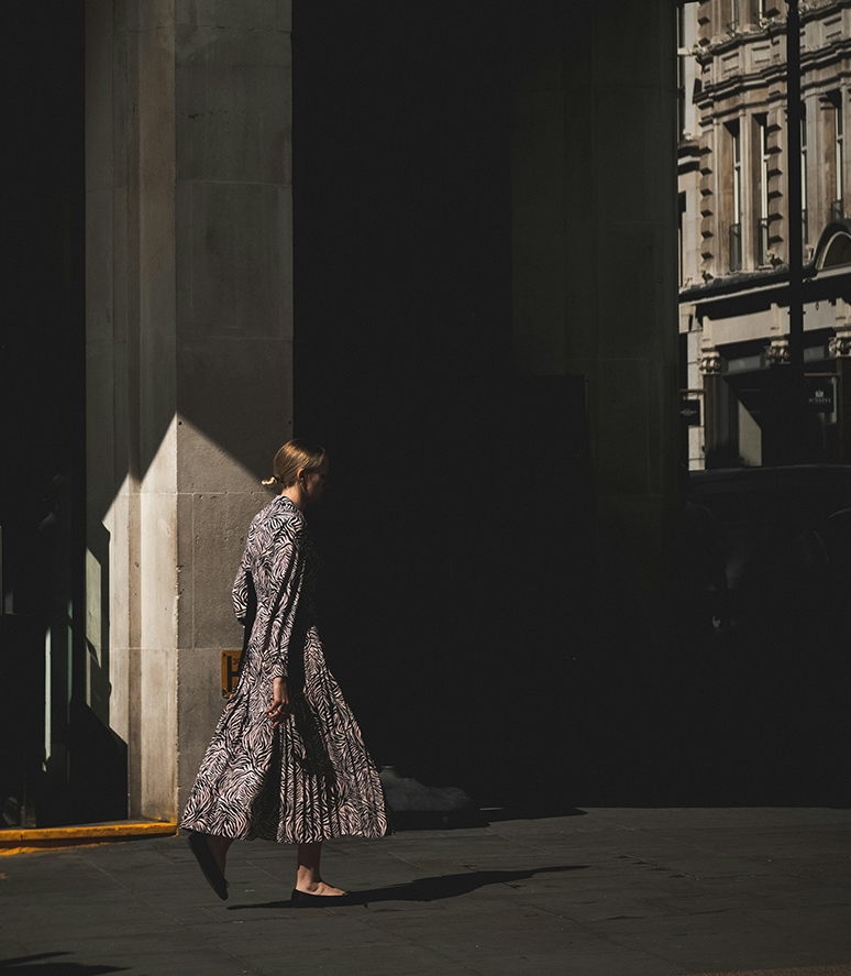 a woman walking in the sun