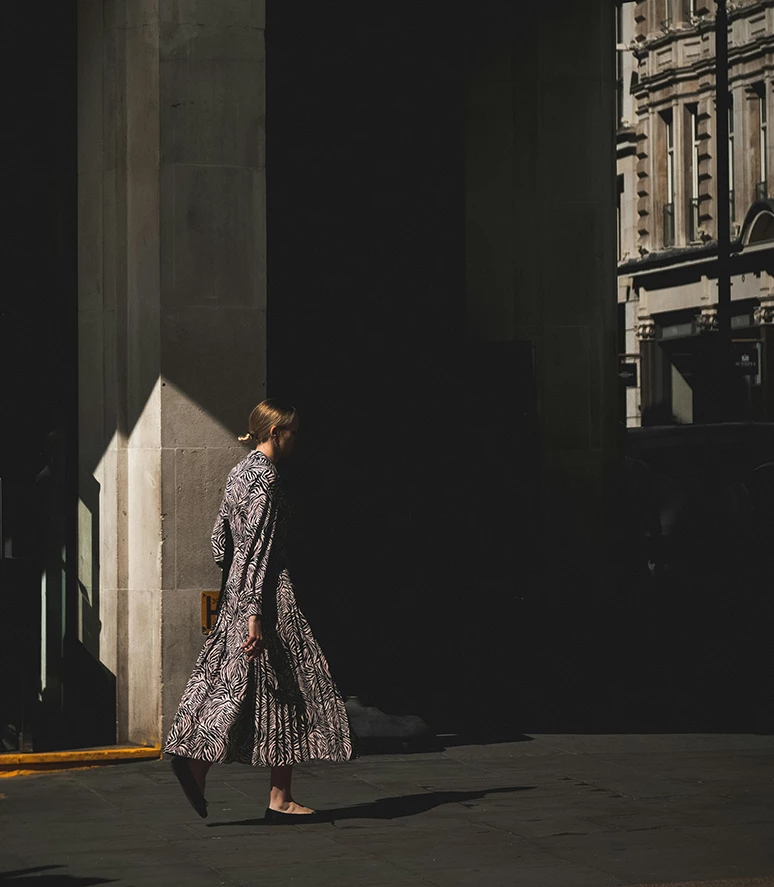 a woman walking in the sun