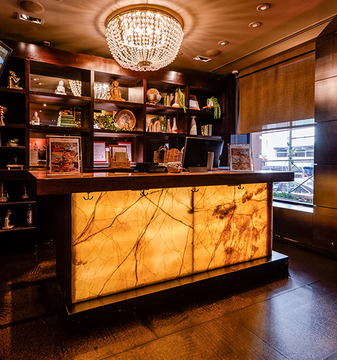 a counter with a chandelier and shelves