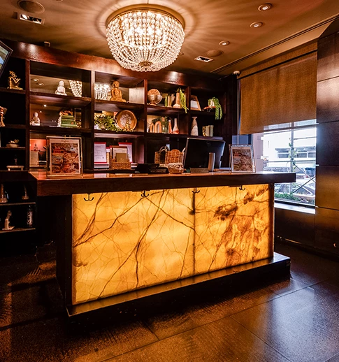 a counter with a chandelier and shelves