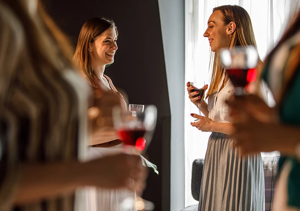 a group of women holding wine glasses