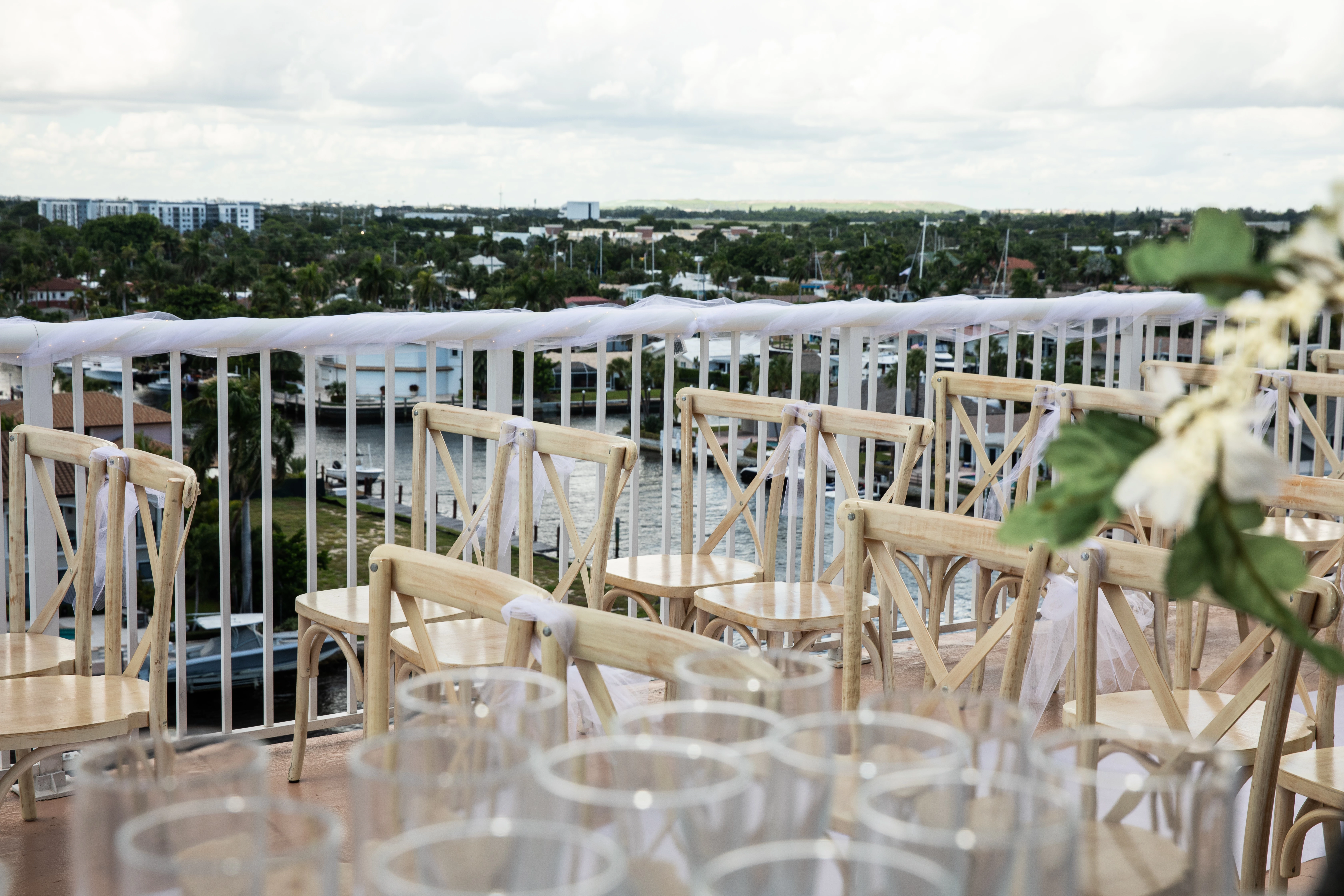 chairs and chairs on a balcony overlooking a city