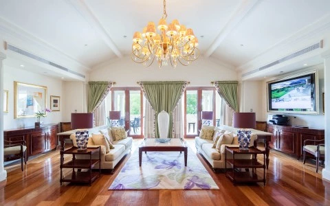 a living room with a chandelier and a large television