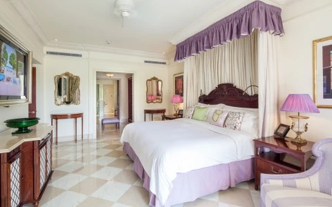 a bedroom with a bed and lamps