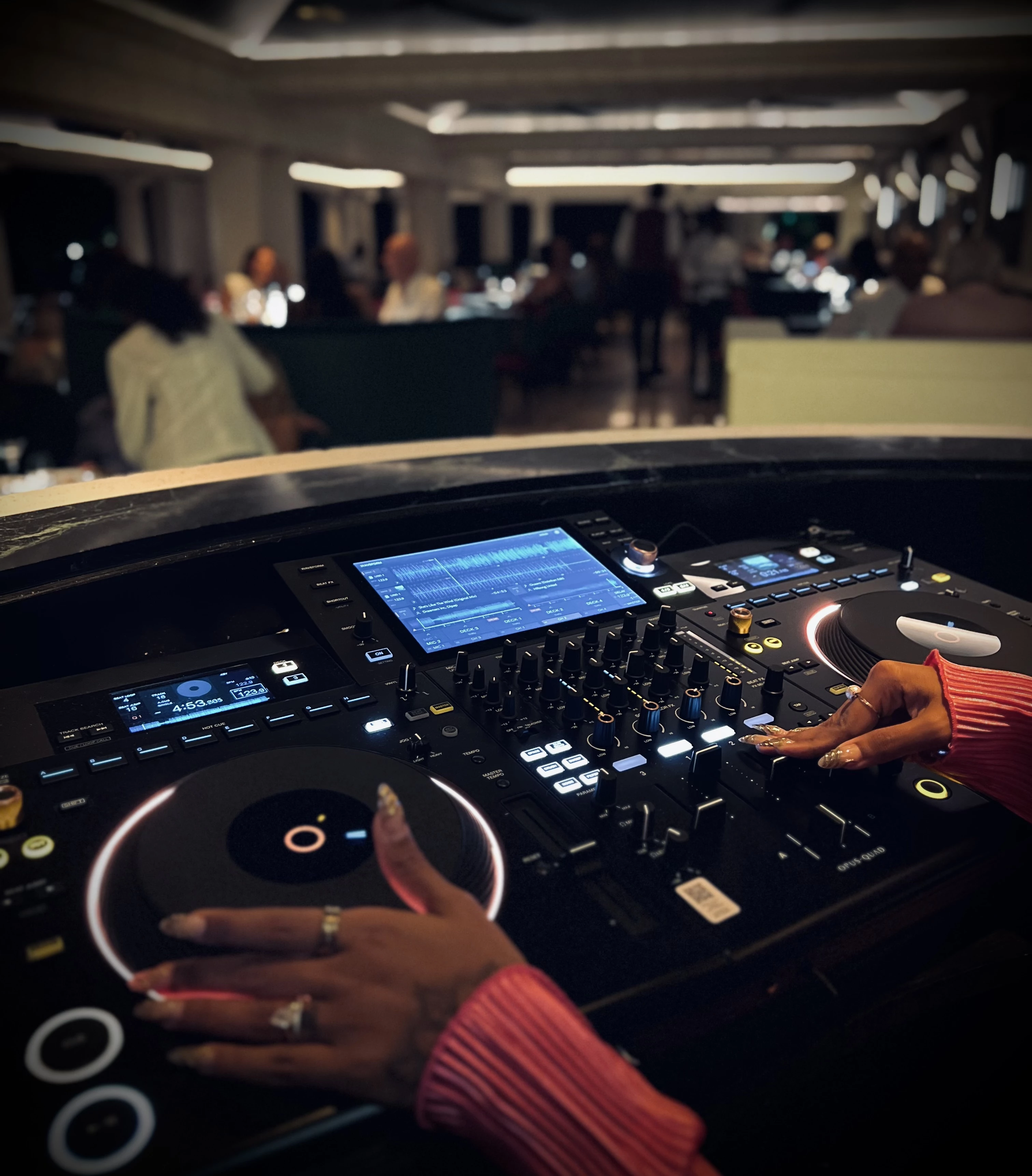 a person's hands on a dj console