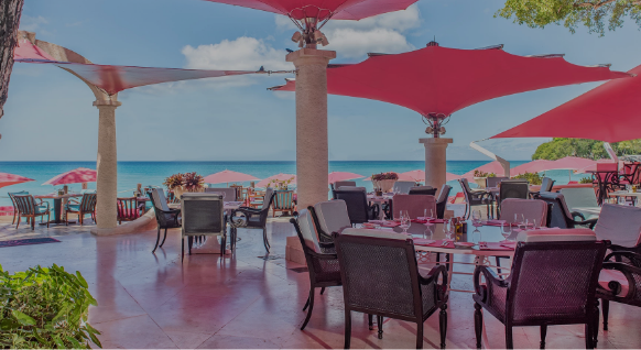 a table and chairs under a red umbrella