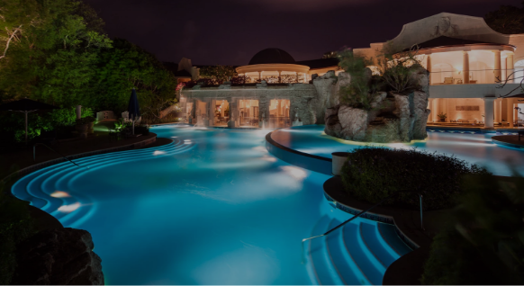 a pool with a building and a building in the background
