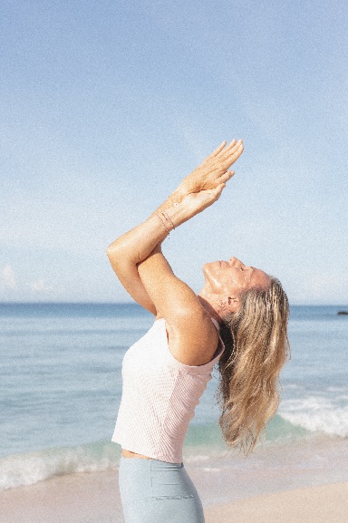 a woman with her arms raised in the air