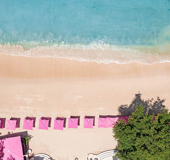 ocean shoreline with many umbrellas on it