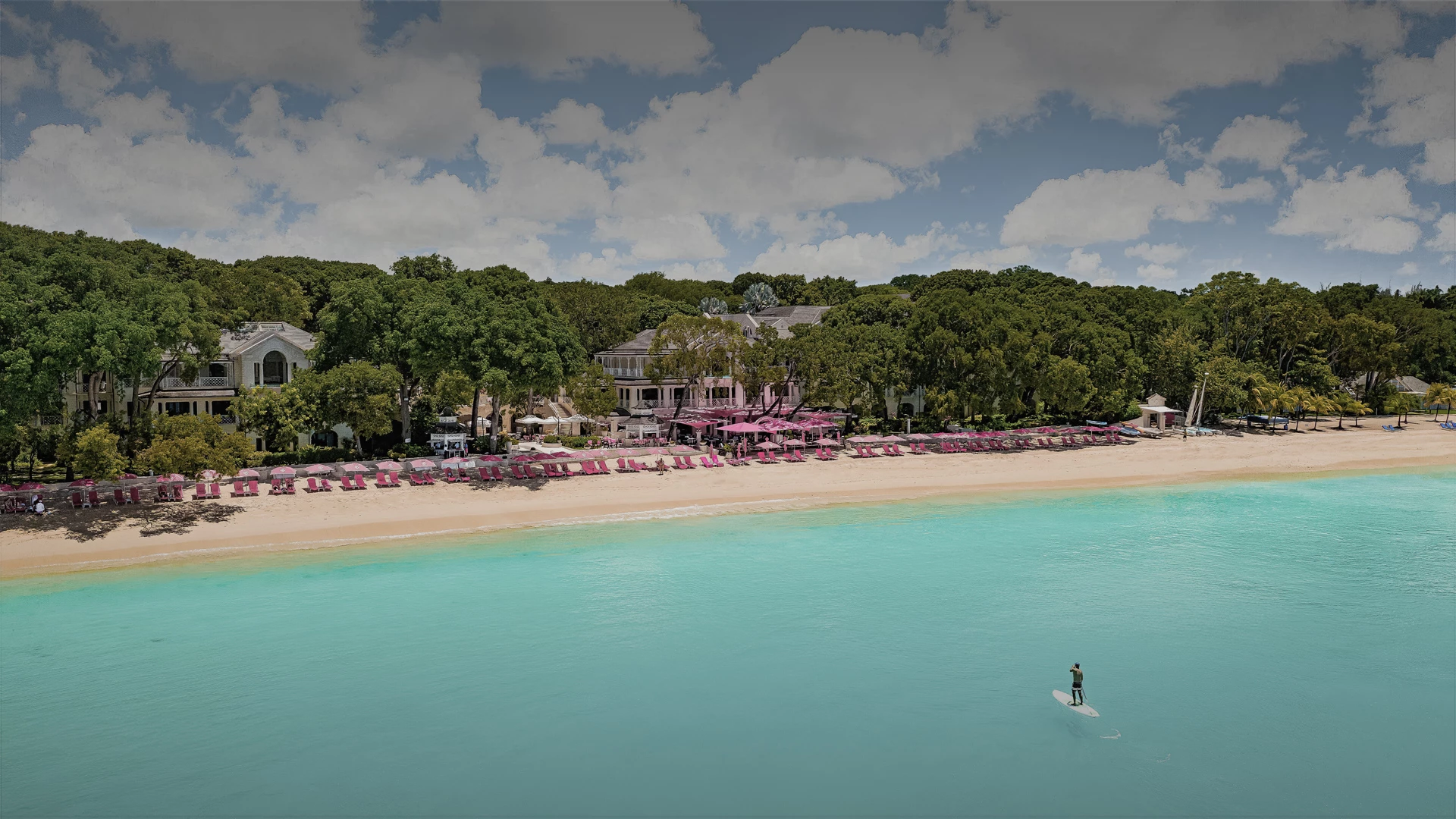 a beach with chairs and tables