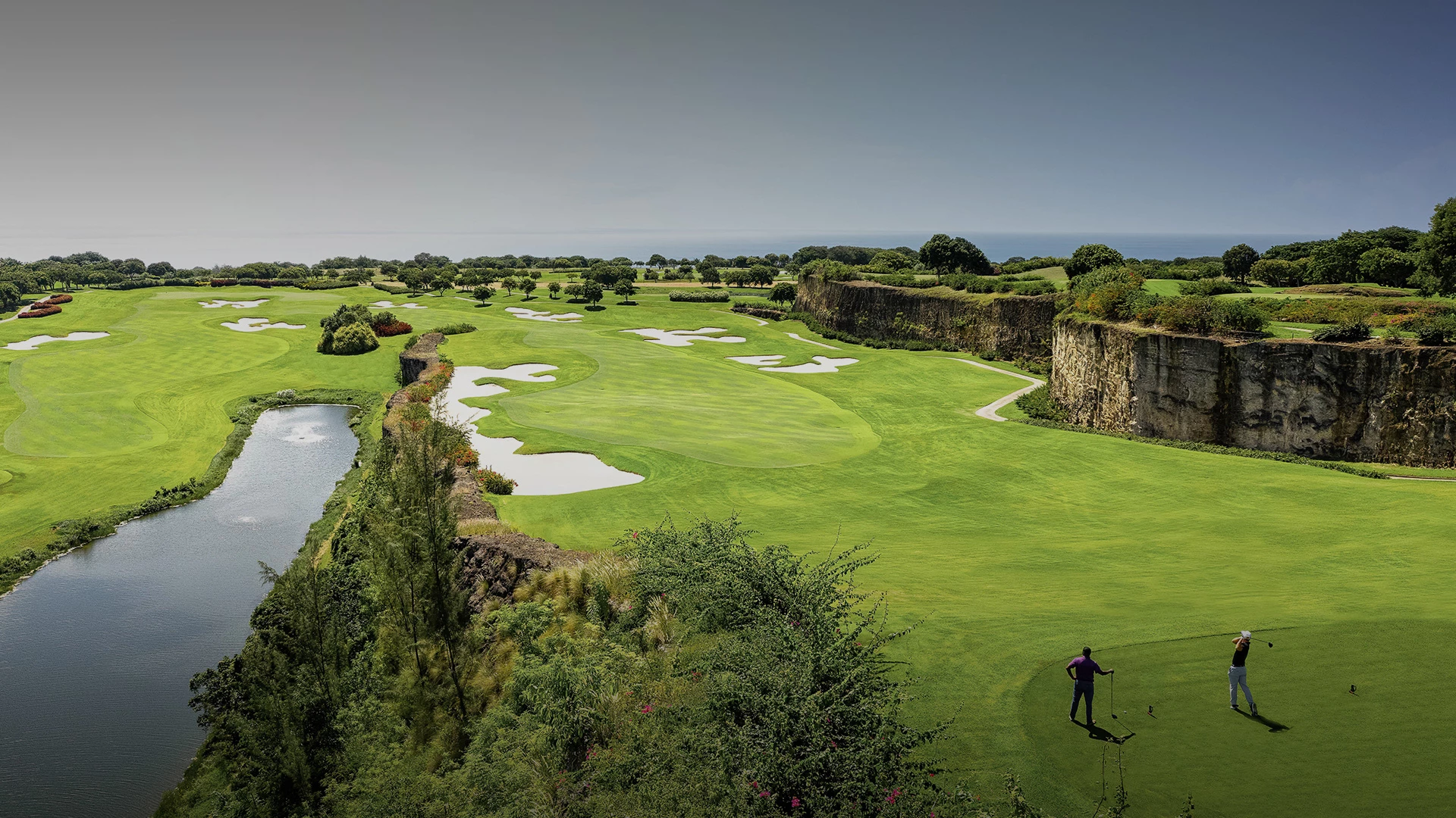 high view of a golf course with a view of the water