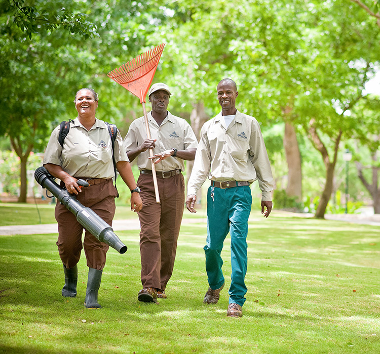 group of people walking with landscape equipment