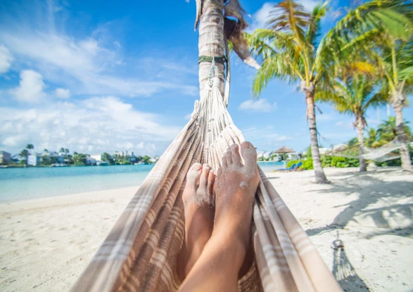 laying down on a hammock with views of the beach