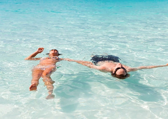 girl and boy floating in the water
