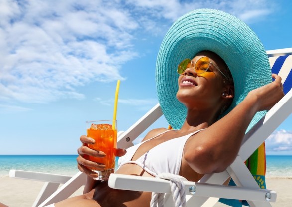 a woman in a garment and hat holding a drink