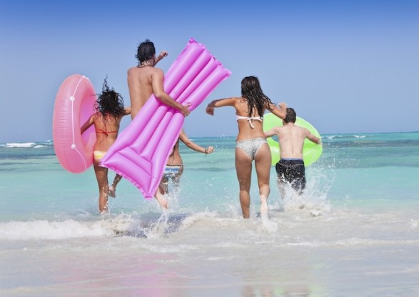 a group of people running in the water