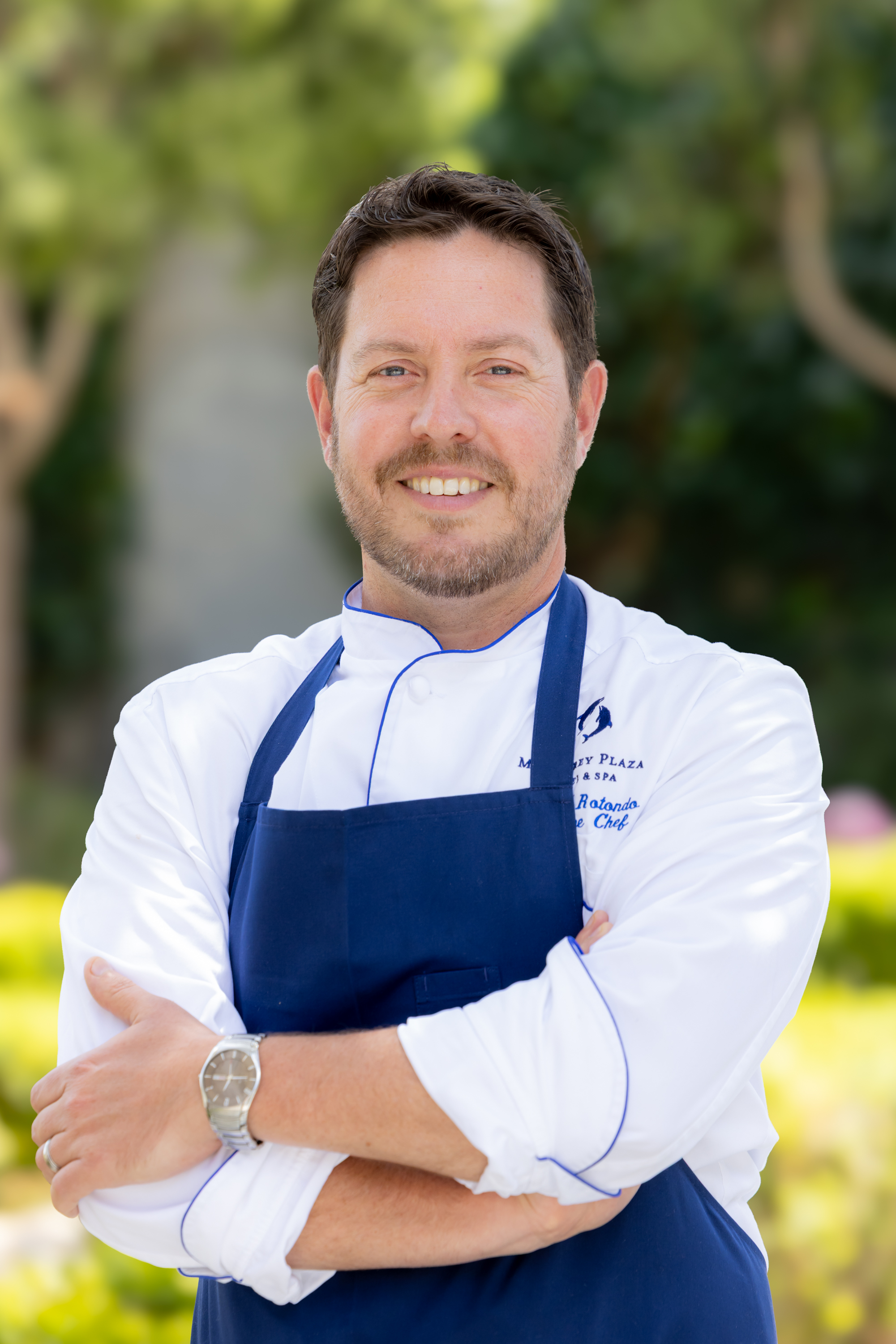 a chef standing with arms crossed
