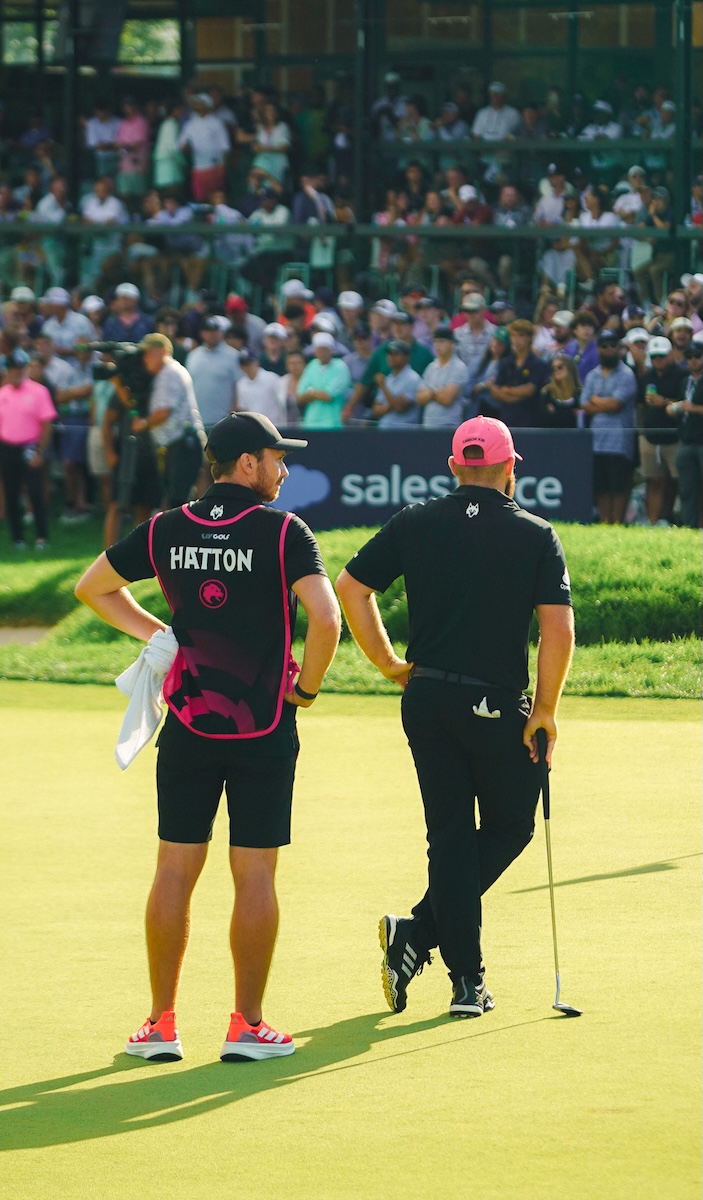 two men standing on a golf course