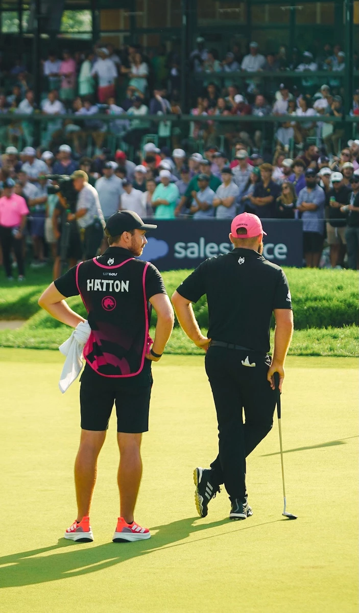 two men standing on a golf course
