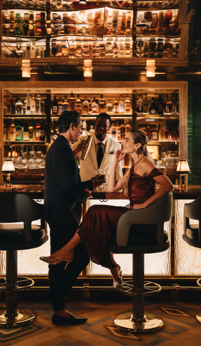 a man and woman sitting at a bar