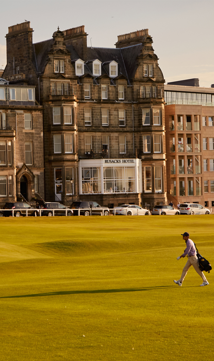 a man walking on a golf course