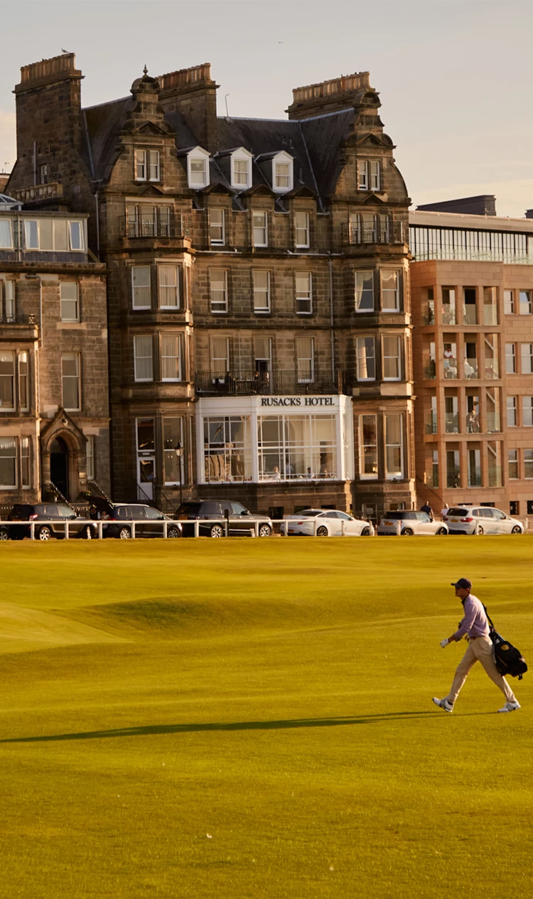 a man walking on a golf course