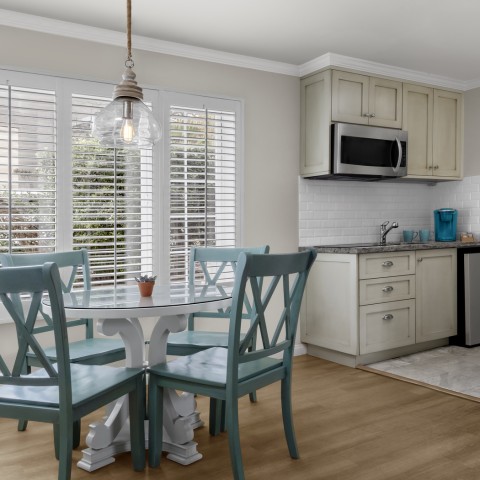 a kitchen with a table and chairs