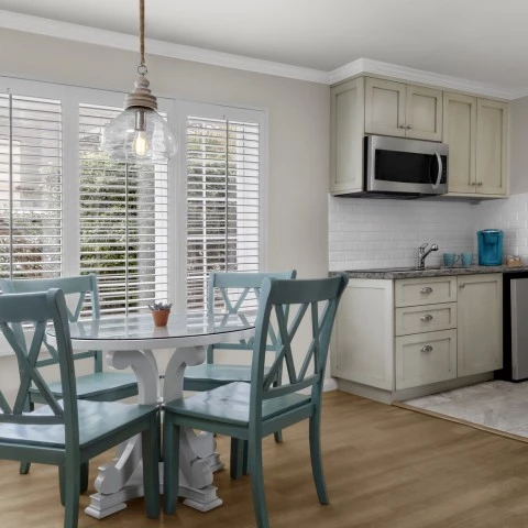 a kitchen with a table and chairs