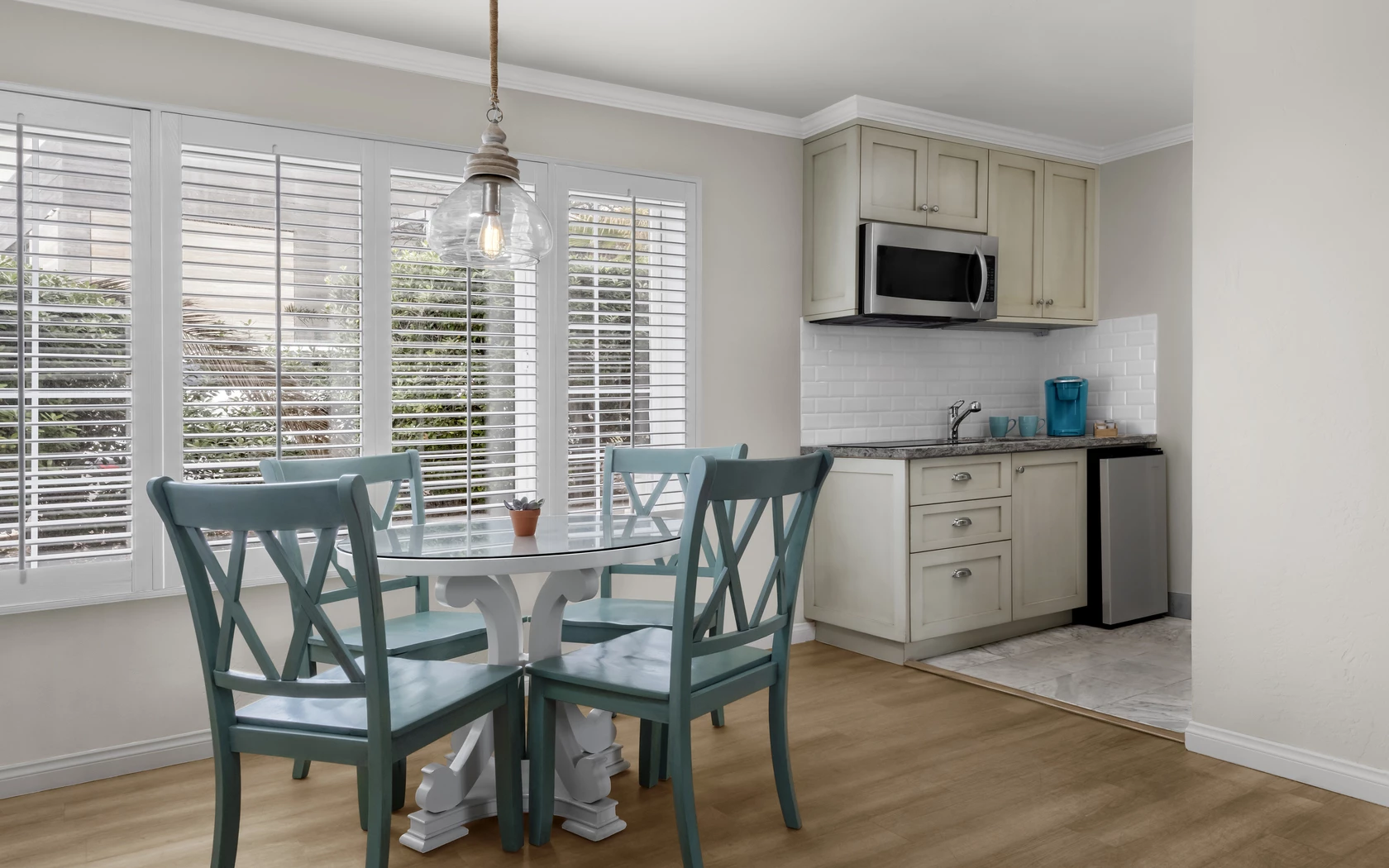 a kitchen with a table and chairs