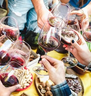 a group of people holding wine glasses