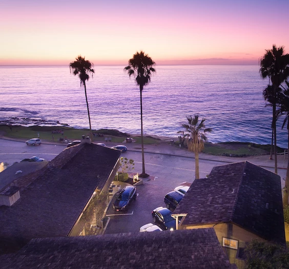 a building with cars parked by the water