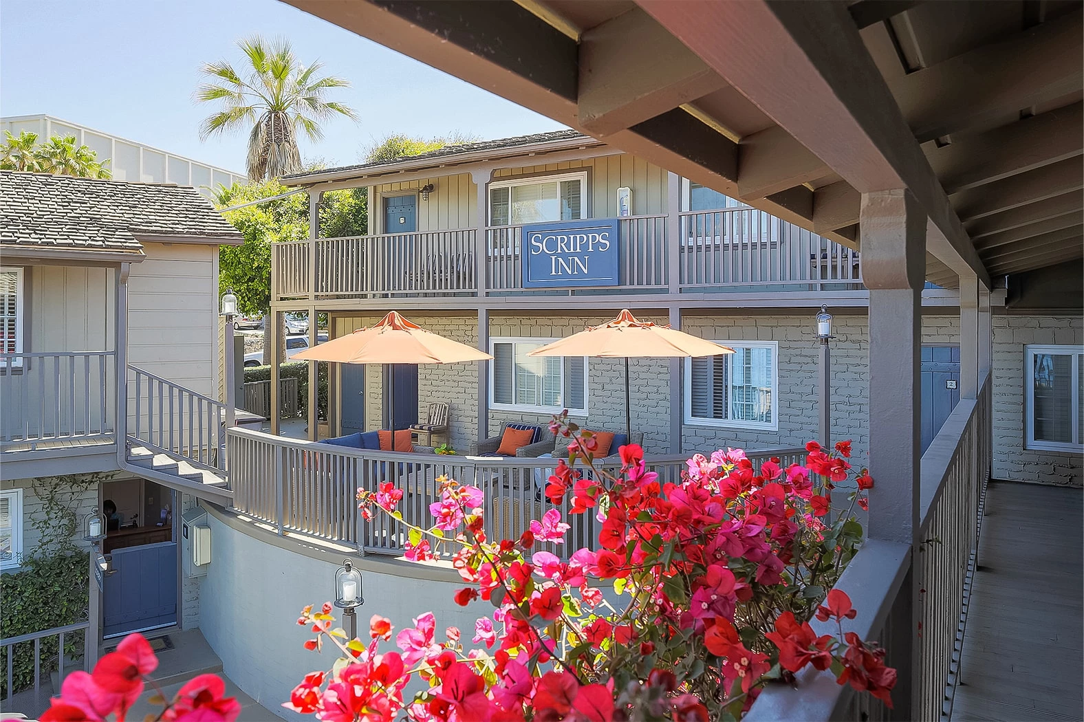 a building with a patio and umbrellas