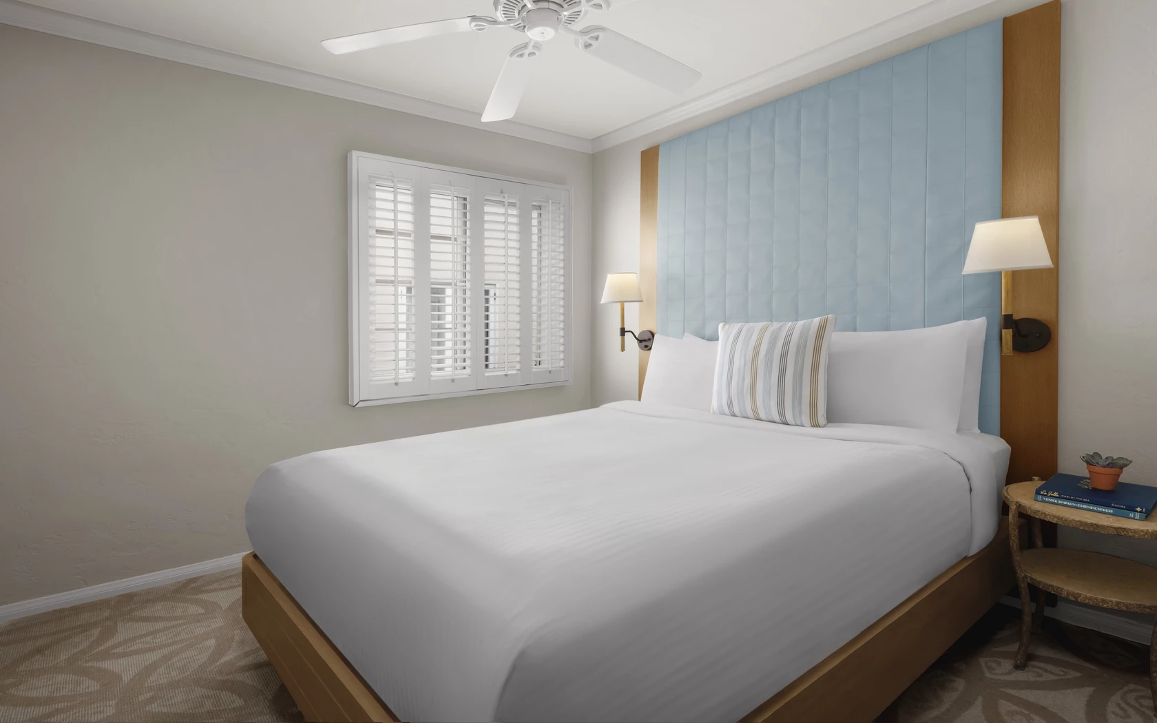 a bed with a fan and a window