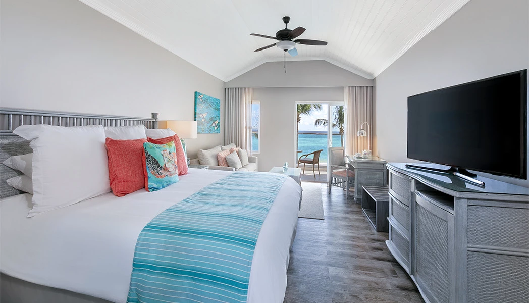 bed with blue stripped bedrunner with tv on dresser