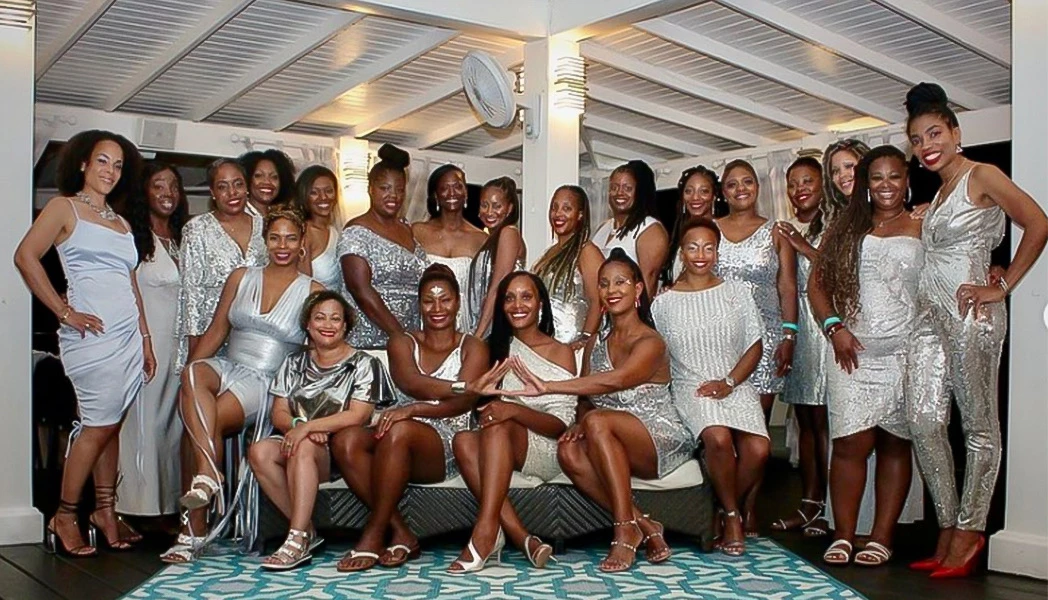 A group of beautiful women wearing silver dresses 