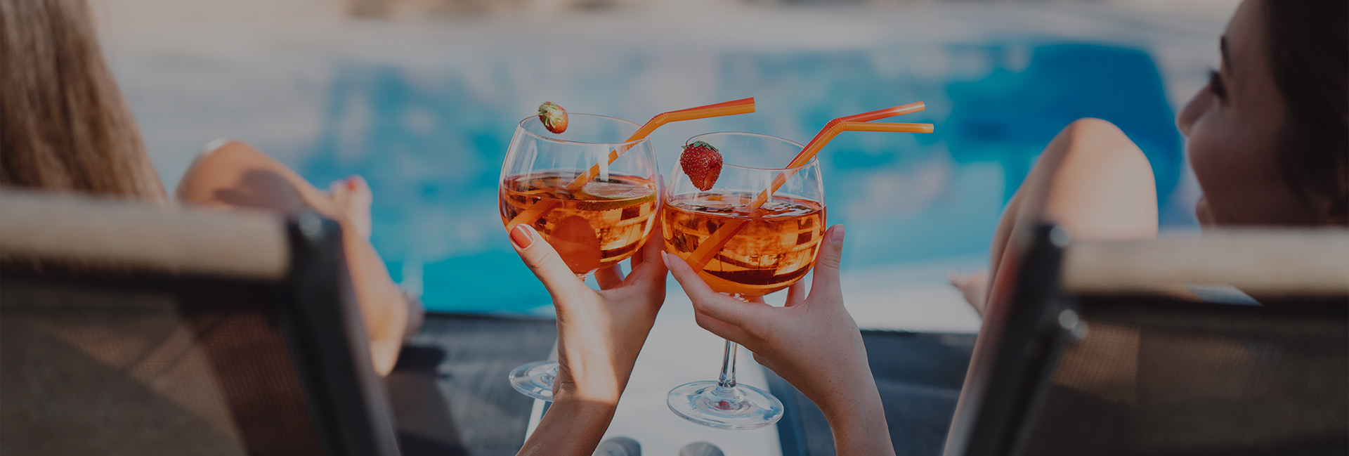 2 women clinking cocktails together