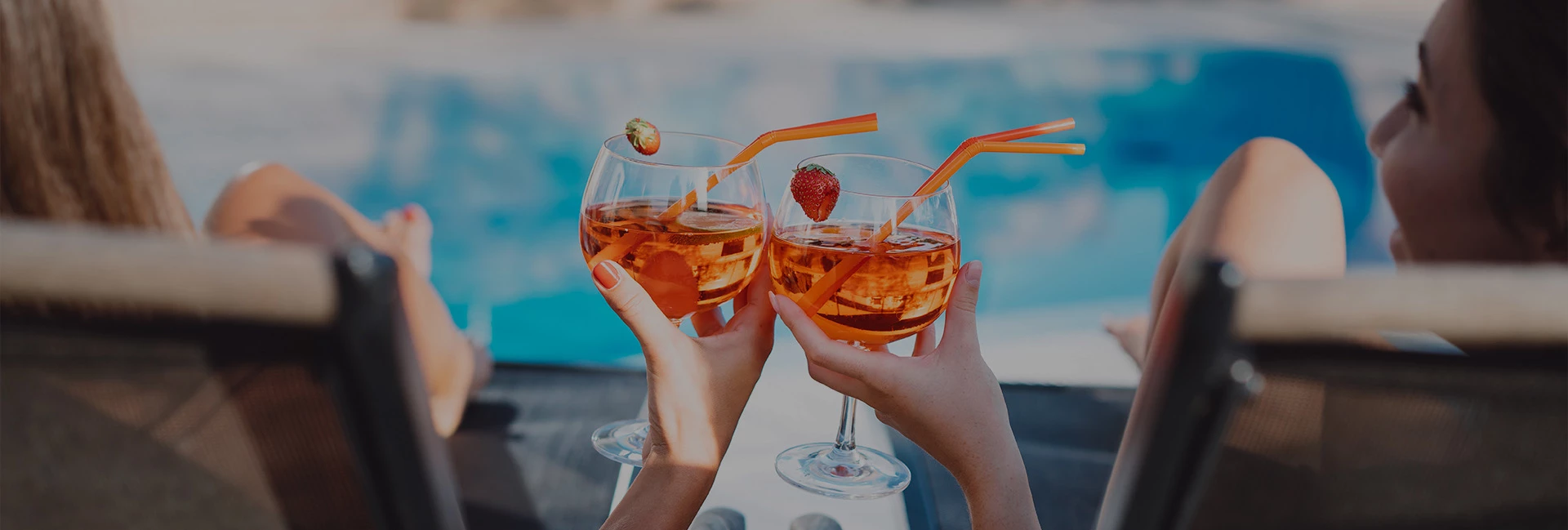 2 women clinking cocktails together