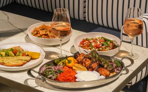 a table with plates of food and wine