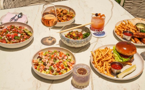 a table with plates of food and drinks