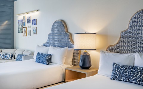 a room with two beds and a lamp