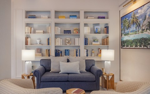 a living room with a couch and bookshelves