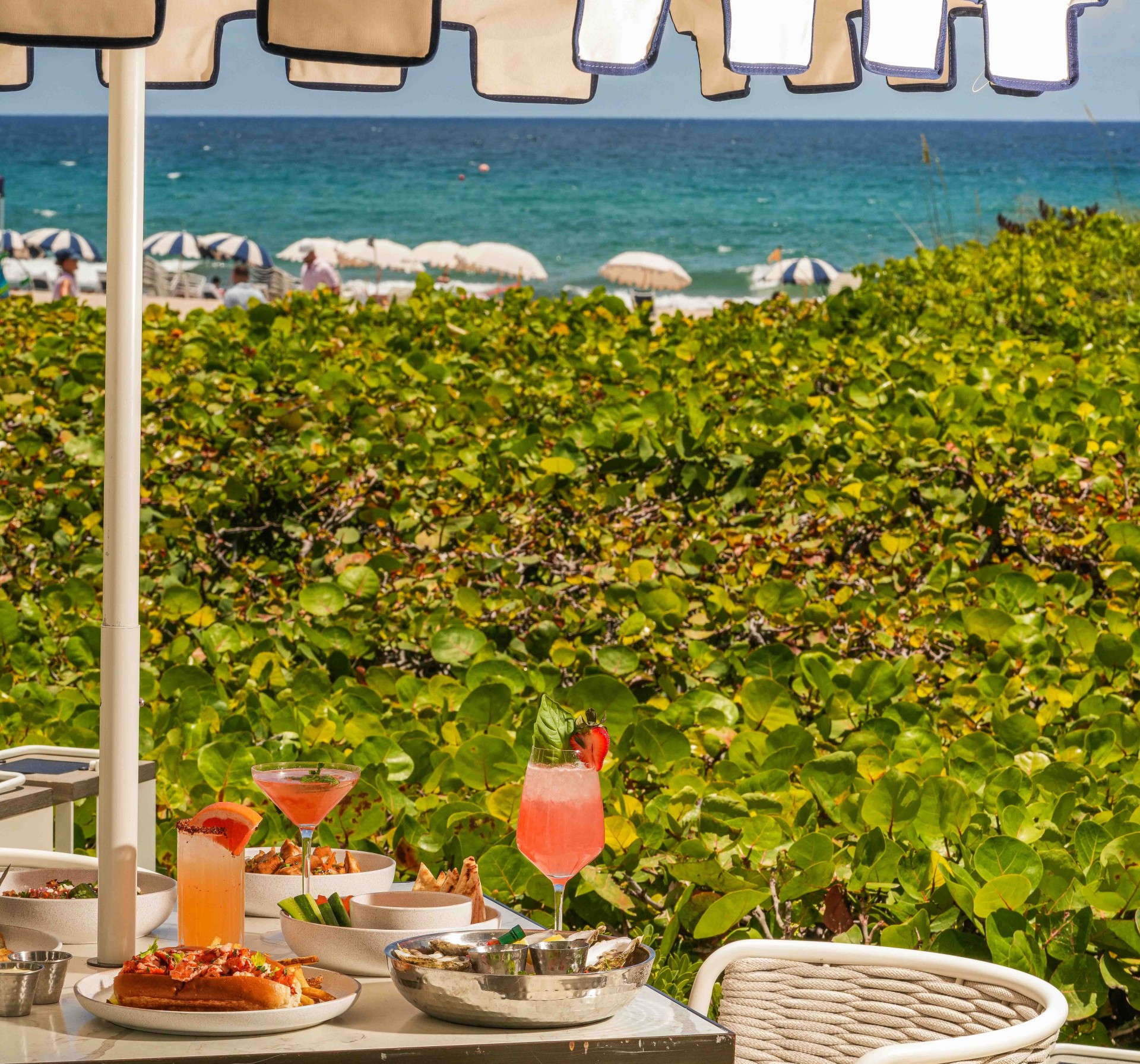 a table with food on it and a beach in the background