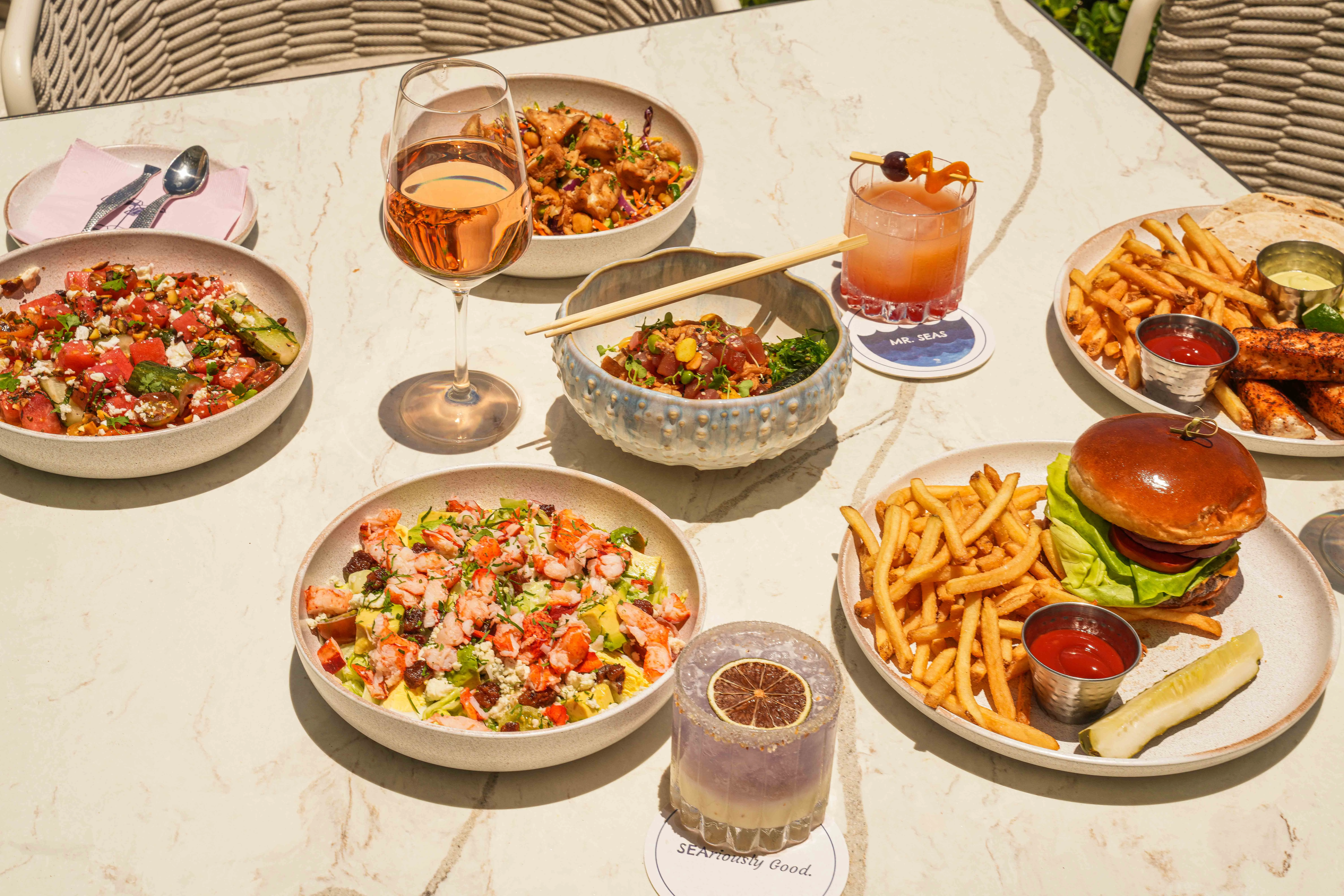 a table with plates of food and drinks