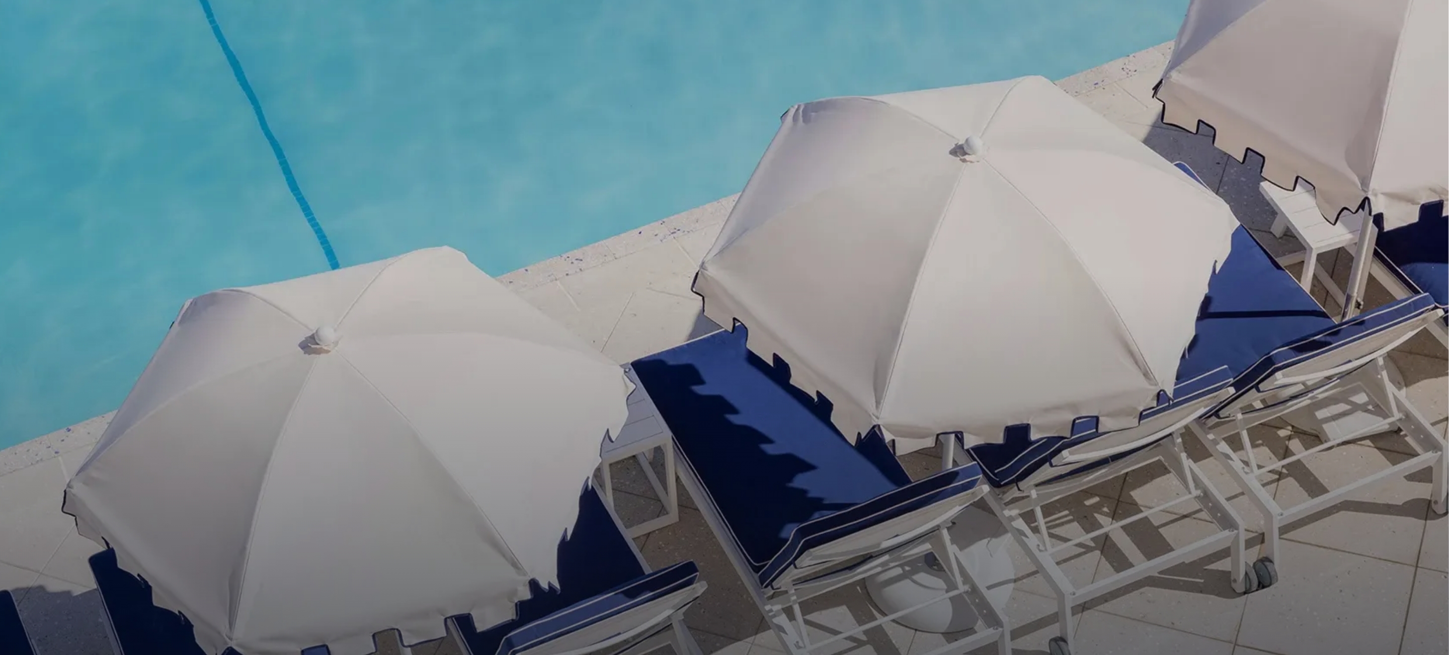 a pool with umbrellas and chairs