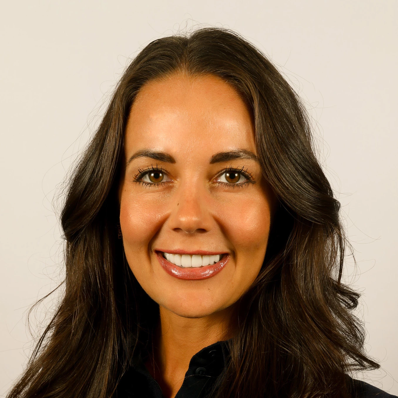 a woman with long brown hair smiling