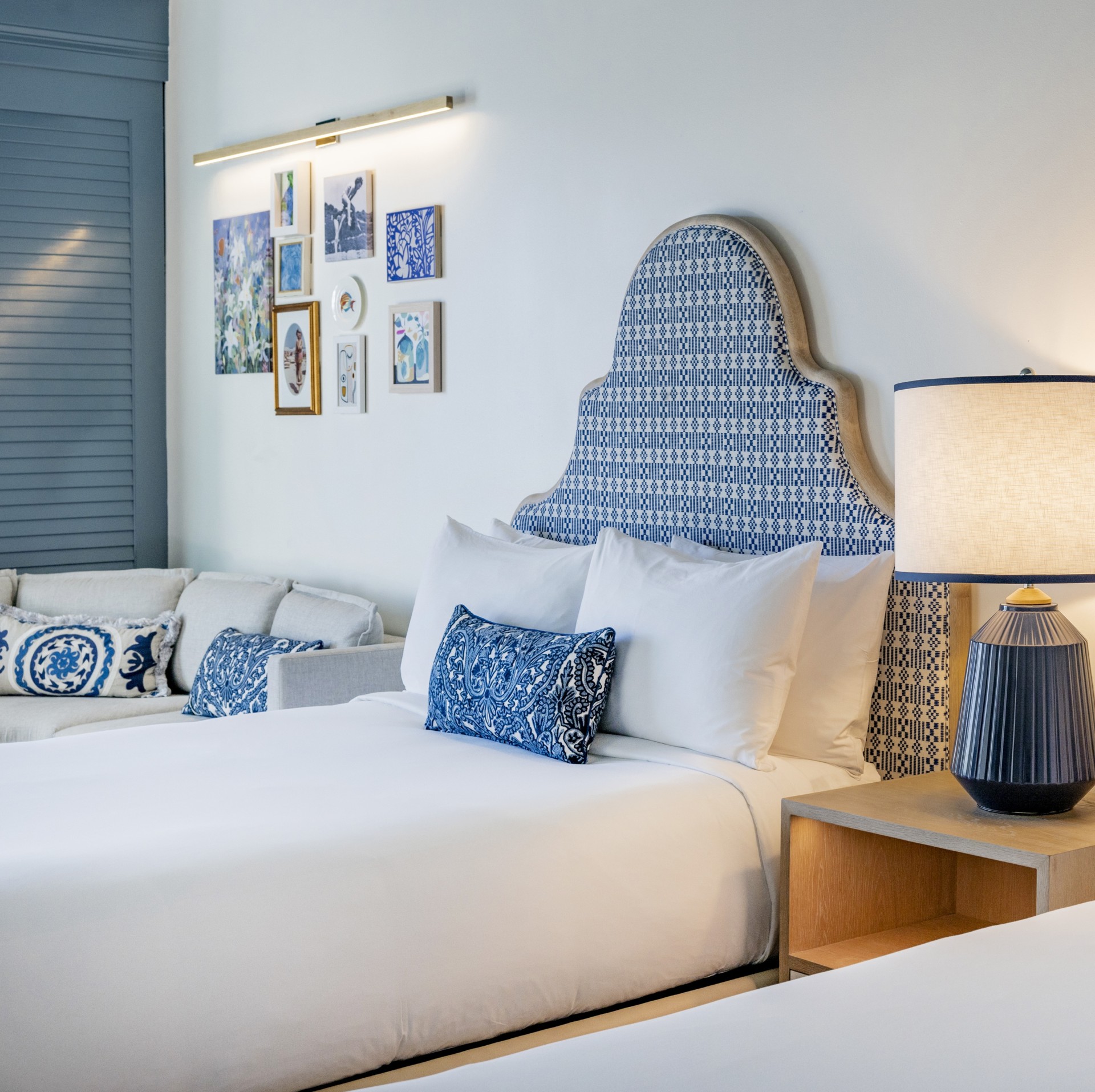 a bed with pillows and a lamp in a room