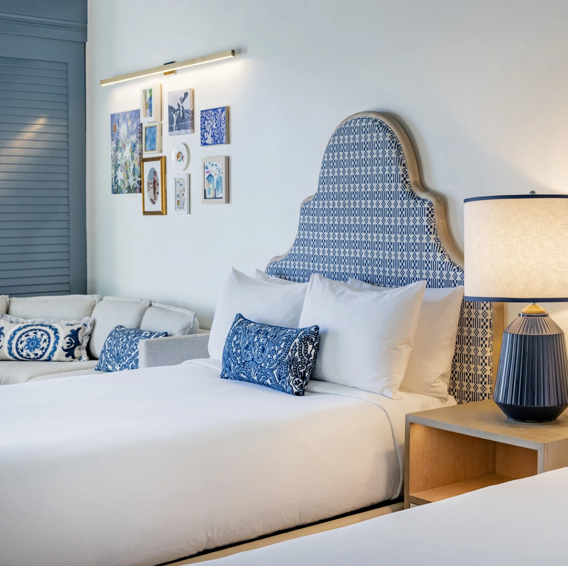 a bed with pillows and a lamp in a room