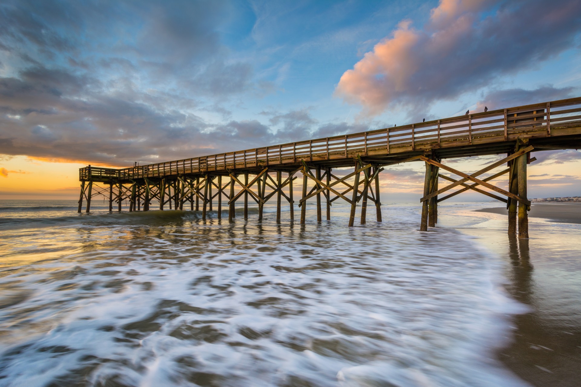 a wooden bridge in the ocean