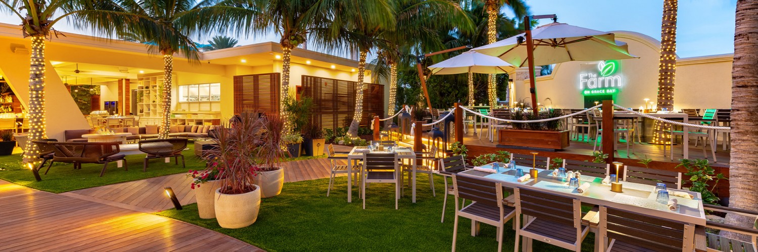 a patio with tables and chairs and umbrellas