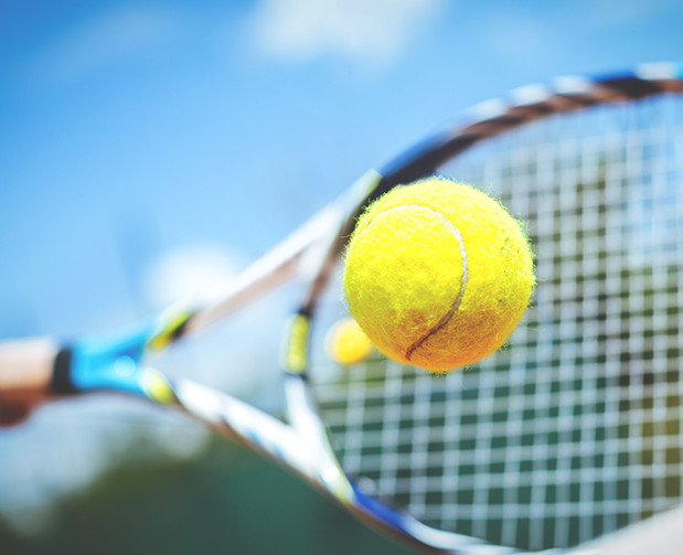 Racket hitting tennis ball